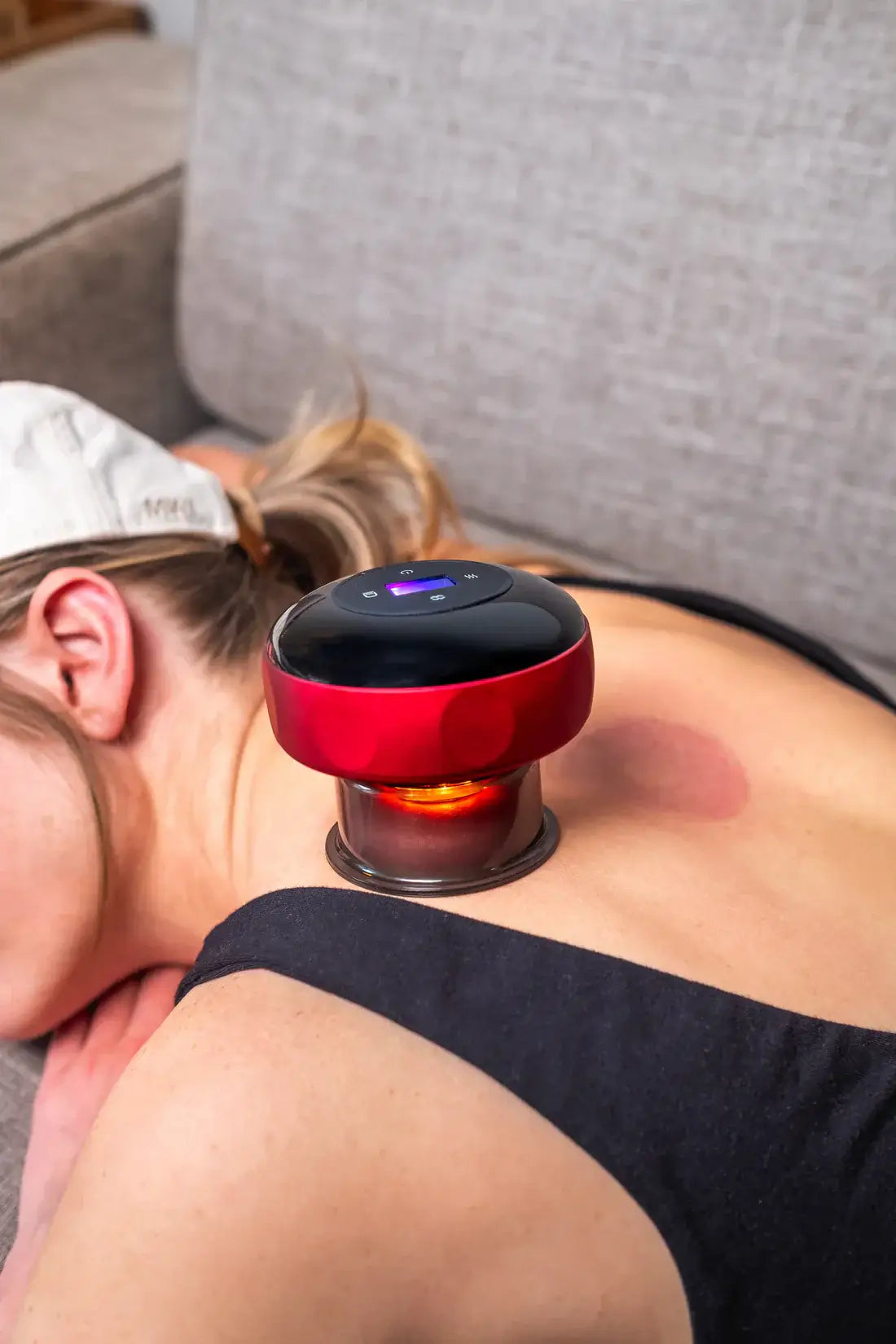 A person using the ELVORAPRO Smart Cupping Massager™ on their back for relaxation and relief.